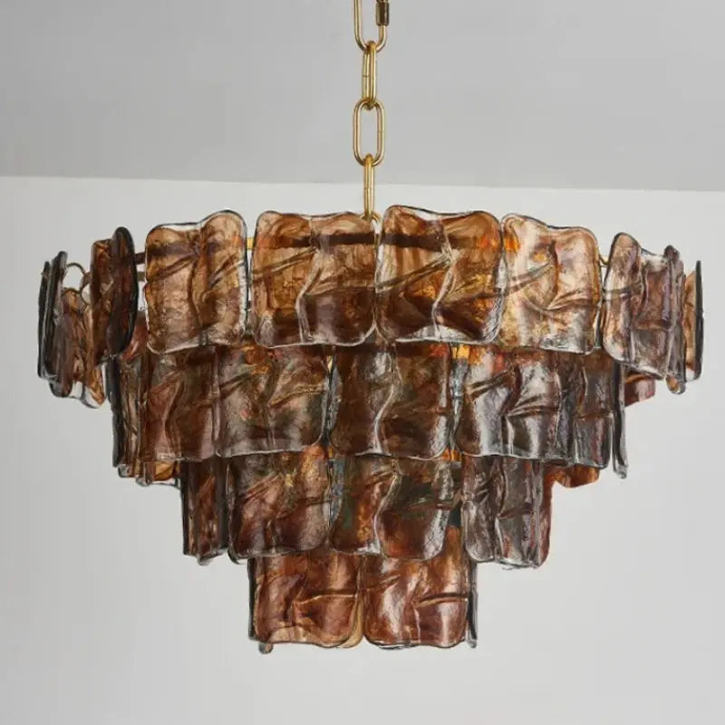 Decorative chandelier with brown glass panels on a gray background