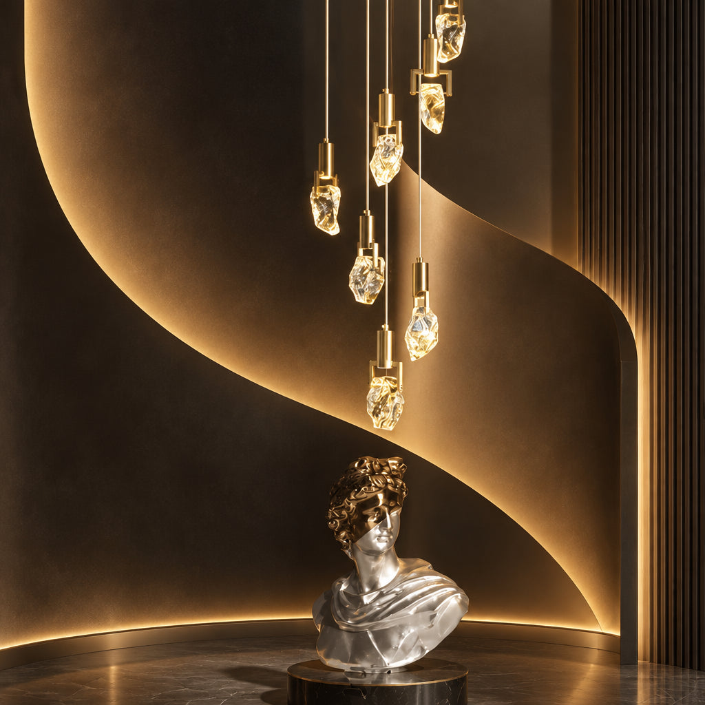 Crystal staircase chandelier with irregular illuminated drops beside a curved staircase and silver bust.