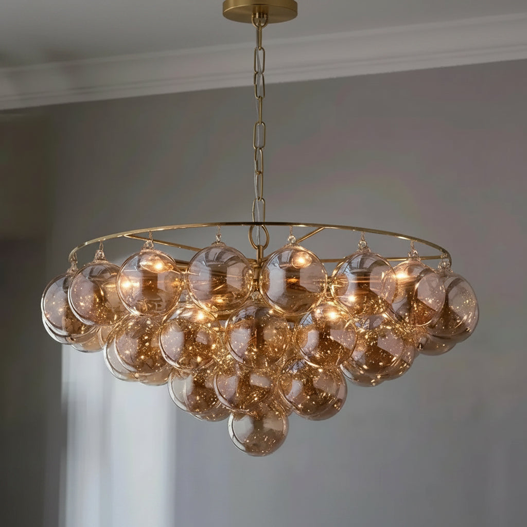 A modern multi-light cluster chandelier with frosted amber glass globes and a gold-toned circular frame, hanging from a chain in an indoor room setting. The brand logo 'Carl Lighting' is visible in the top left corner.