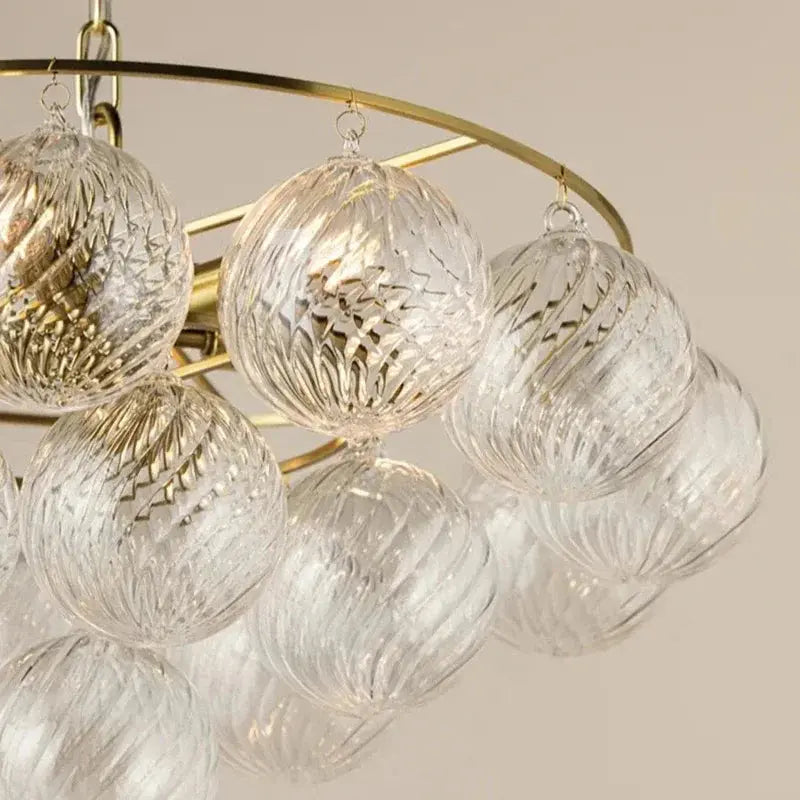 Chandelier with glass globe lights on a neutral background