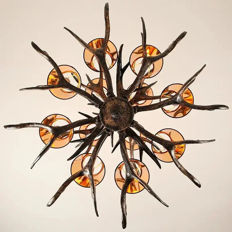 Decorative chandelier with antler-like design and amber-colored lights on a beige background