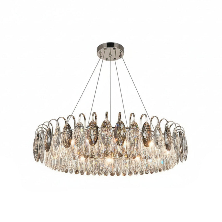 Chandelier hanging in a living room with dark walls and a gray sofa.