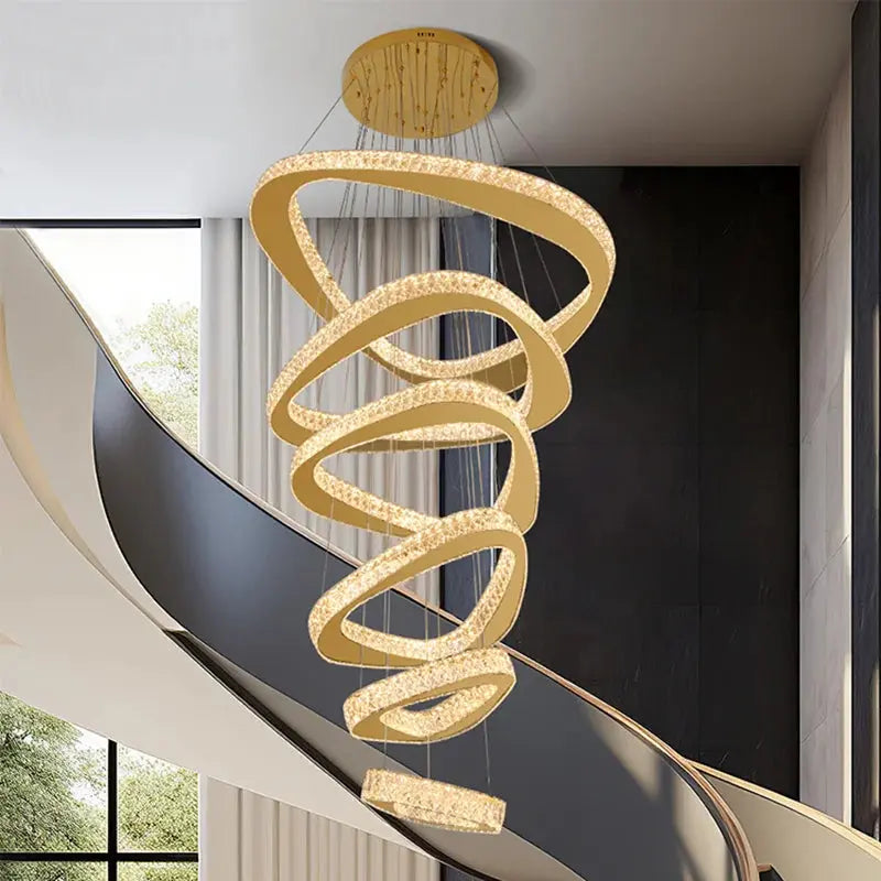 Modern chandelier hanging in a room with a staircase