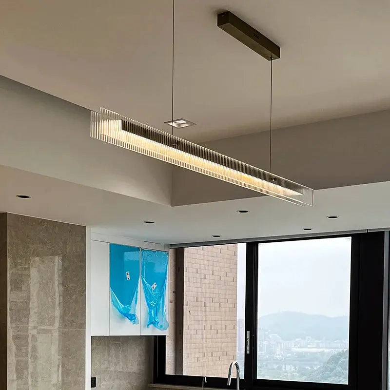 Minimalist Black Linear Chandelier Above Dining Table