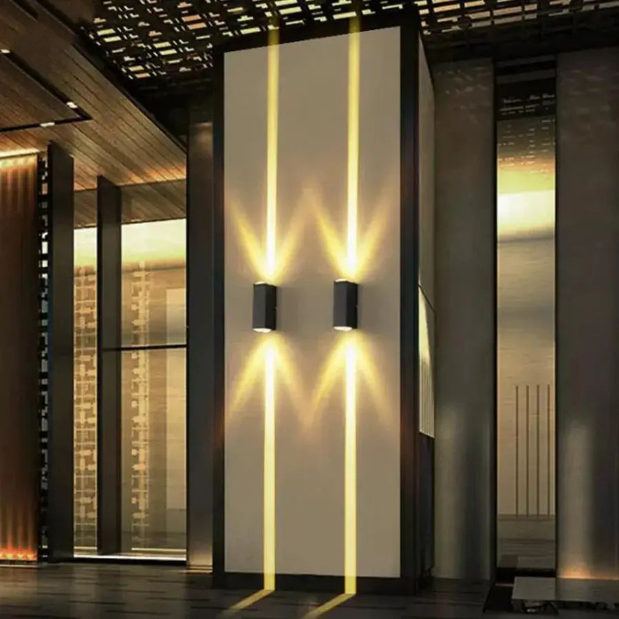 Modern wall lights on a building exterior with a cityscape background