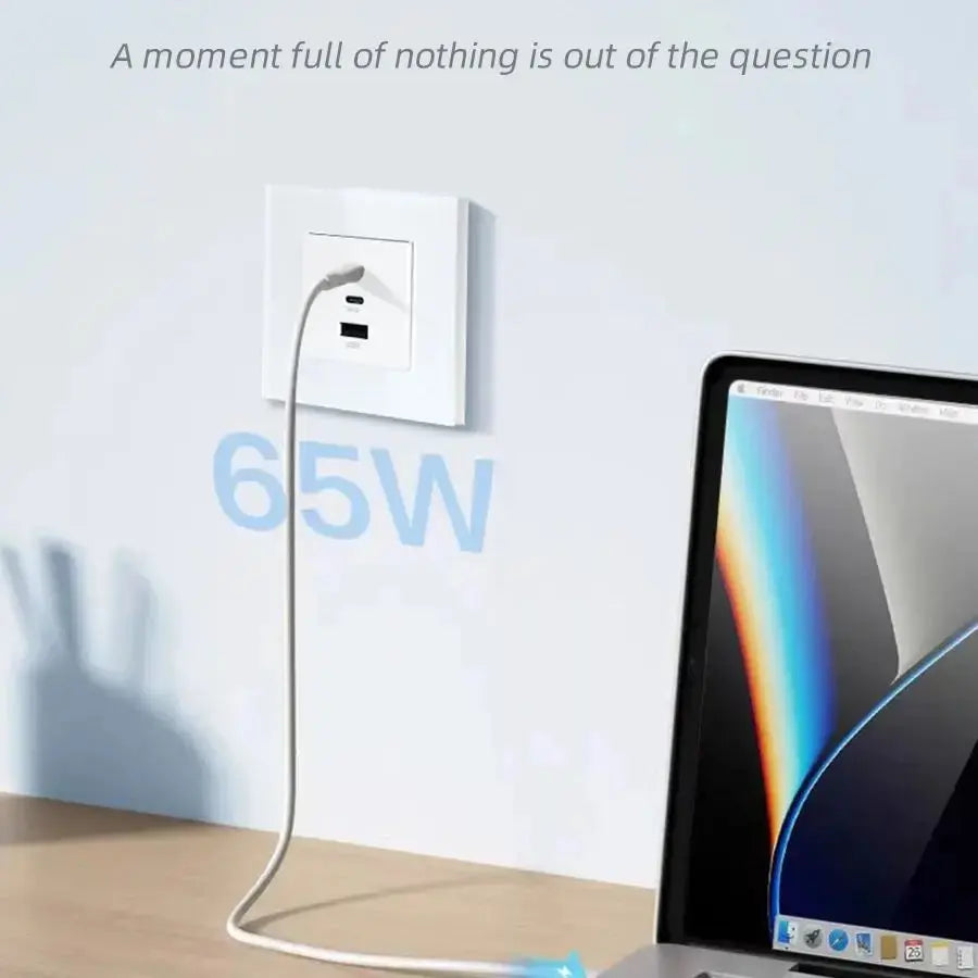 Laptop charging cable with 65W power adapter on a desk